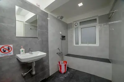 a bathroom with a sink and a mirror at Silver Heaven, Kotagiri in Kotagiri