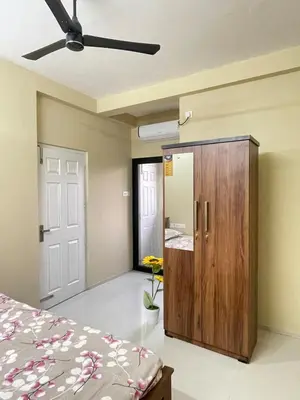 a bedroom with a bed and a ceiling fan at Le Divine C3 Premium 1bhk Apartment 100meters from Guruwayur temple in Guruvāyūr