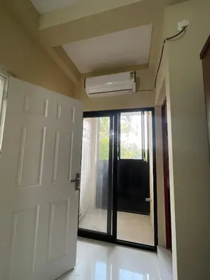 an empty room with a door and a fan at Le Divine C3 Premium 1bhk Apartment 100meters from Guruwayur temple in Guruvāyūr