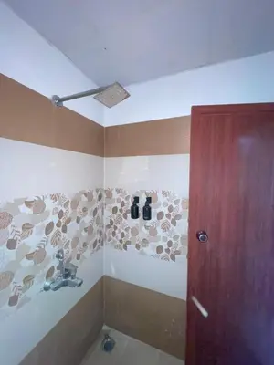 a bathroom with a shower with a sink at Le Divine C3 Premium 1bhk Apartment 100meters from Guruwayur temple in Guruvāyūr