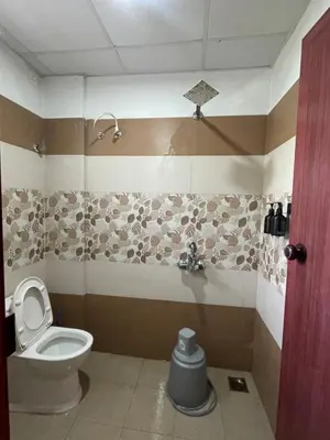 a bathroom with a toilet and a sink at Le Divine C3 Premium 1bhk Apartment 100meters from Guruwayur temple in Guruvāyūr