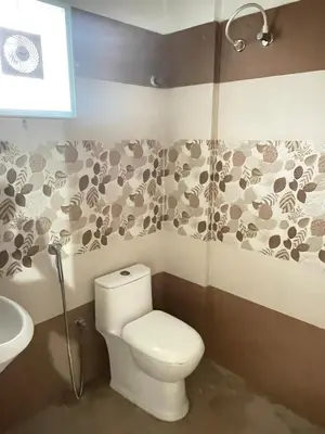 a bathroom with a toilet and a sink at Le Divine C3 Premium 1bhk Apartment 100meters from Guruwayur temple in Guruvāyūr