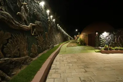 a stone wall with lights on it at night at Lake Lagoon Moonhills in Mennānyam