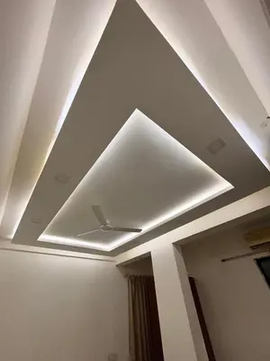 a ceiling with a ceiling fan in a room at Isha suites in Mysore