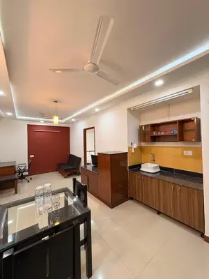 a large room with a kitchen and a living room at Isha suites in Mysore