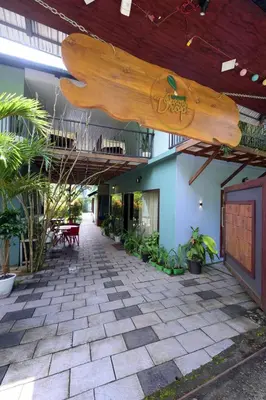 a large wooden board hanging from the ceiling of a building at Snow Drops Resort in Vythiri