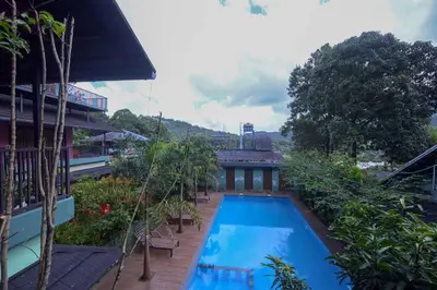 a swimming pool on the side of a building at Snow Drops Resort in Vythiri