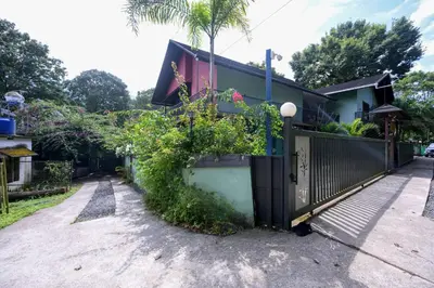 a house with a fence and plants on it at Snow Drops Resort in Vythiri