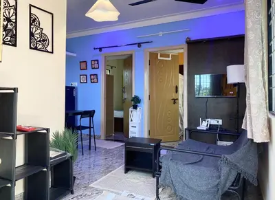 a living room with blue walls and a desk at Mindful Rooftop Yoga Stay in Gokulam Bright, Airy Private Family Terrace Apartment in Mysore