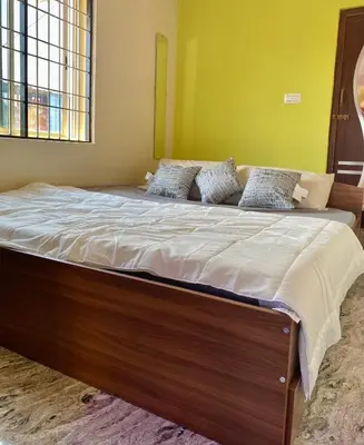 a large bed with white sheets and pillows on it at Mindful Rooftop Yoga Stay in Gokulam Bright, Airy Private Family Terrace Apartment in Mysore