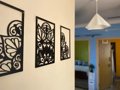 three framed pictures hanging on a wall at Mindful Rooftop Yoga Stay in Gokulam Bright, Airy Private Family Terrace Apartment in Mysore