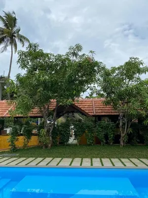 a house with a pool in front of it at Ponyo Stays in Cochin