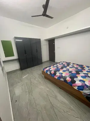 a bedroom with a bed and cabinets and a ceiling at Mount holidays in Meppādi
