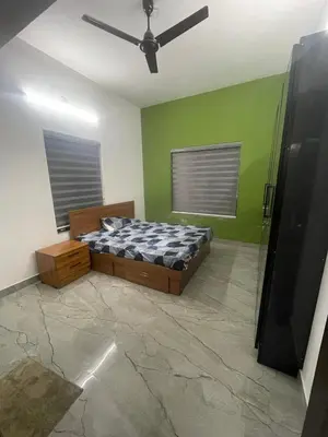a bedroom with a bed and a ceiling fan at Mount holidays in Meppādi