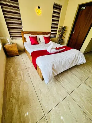 a bedroom with two beds with red and white sheets at Ronz Vista Mount Villa in Padinjarathara