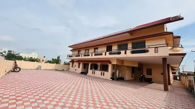 a large building with a red brick courtyard at Sindhu Residency in Coimbatore