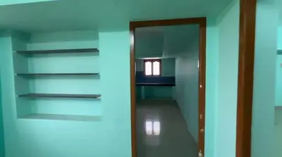 an empty room with a glass door and a hallway at Sindhu Residency in Coimbatore