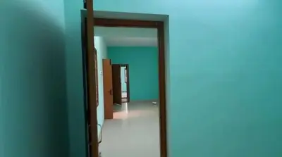 an open door to a room with blue walls at Sindhu Residency in Coimbatore