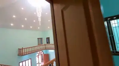 a room with a staircase and a chandelier at Sindhu Residency in Coimbatore