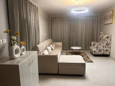a living room with a couch and a chair at Aloka Cordial Luxury Residences in Trichūr