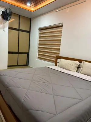 a bedroom with a large bed and a window at ARAMAM SERVICE VIlla in Mananthavady