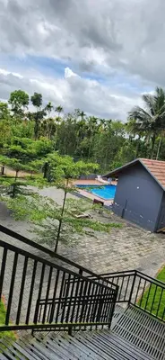 a view of a building with a swimming pool at WILD WIND Resort in Muthanga