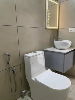 a bathroom with a toilet and a sink at Vijaya Home Stay in Batheri