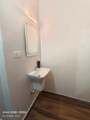 a bathroom with a sink and a mirror at Mathew's Haven, Wayanad - By Arattukulam Hospitality in Thirunelli