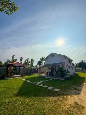a large white house in a grassy yard at White House, Managed By Triora Escapes in Maddūr