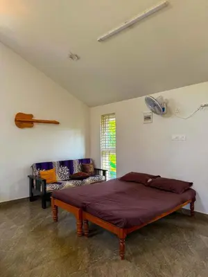 a bedroom with a bed and a couch at White House, Managed By Triora Escapes in Maddūr