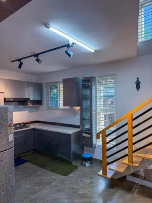 a kitchen with a counter and a staircase in a room at White House, Managed By Triora Escapes in Maddūr