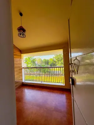 a room with a balcony with a large window at White House, Managed By Triora Escapes in Maddūr