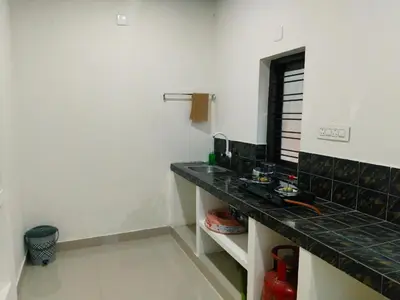 a bathroom with a black counter top in a room at Vythiri Silent Leaf in Wayanad