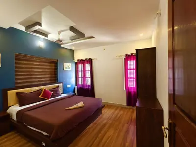 a bedroom with a bed and red windows at z in wayanad in Kalpetta