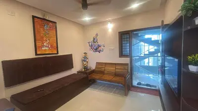 a living room with a bench and a fish tank at Kalpaka in Guruvāyūr