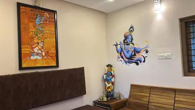 a room with a large painting on the wall and avertisement at Kalpaka in Guruvāyūr