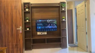 a television in a book shelf in a hallway at Kalpaka in Guruvāyūr