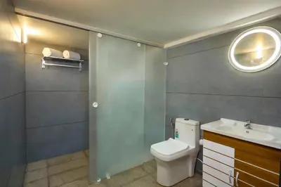 a bathroom with a toilet and a sink and a mirror at Akanta Cherai Beach Resort in Cochin