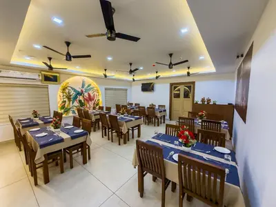 a restaurant with tables and chairs in a room at PANCHAVADY RESIDENCy in Kodungallūr