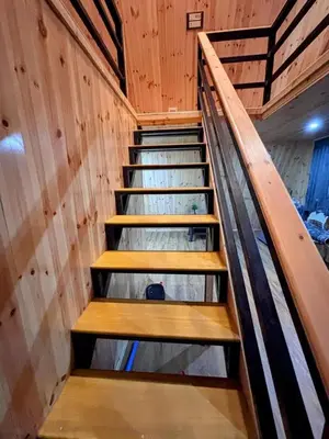 a set of stairs in a room with wooden walls at AURA Resort kookal kodaikanal in Kūkkāl