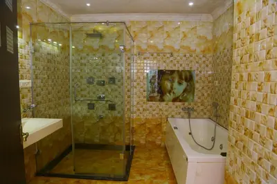 a bathroom with a shower and a tub and a sink at Celestial Resorts in Kotagiri