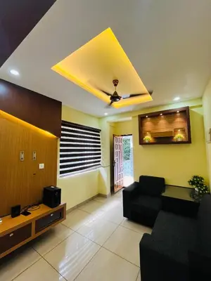 a living room with a couch and a tv at panakkal tower in Guruvāyūr