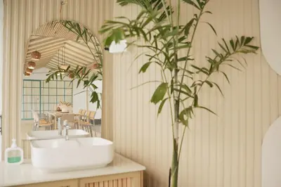 a bathroom with a sink and a plant at The Soul by VDN A Santorini inspired Villa in Trichūr