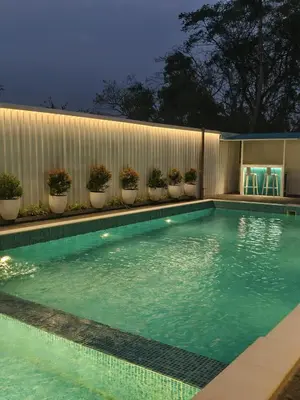 a swimming pool with plants on the side of a building at The Soul by VDN A Santorini inspired Villa in Trichūr