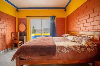 a bedroom with a wooden bed with a window at The Blue Hist in Naduvattam