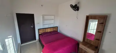 a bedroom with a purple bed and a mirror at Mocha Valley Homestay in Kalpetta