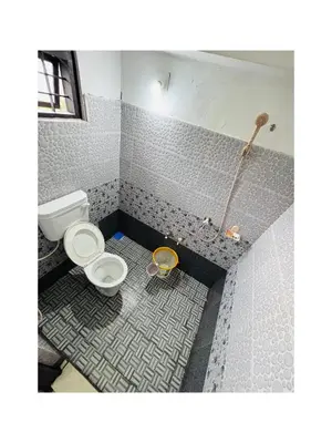 a bathroom with a toilet and a shower at Mocha Valley Homestay in Kalpetta