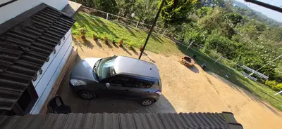 a small car parked next to a building at Mocha Valley Homestay in Kalpetta