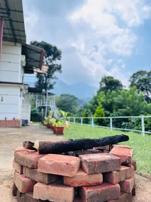 a stack of red bricks with a tire on top at Mocha Valley Homestay in Kalpetta