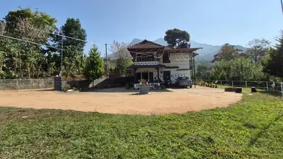 a small building in the middle of a field at Mocha Valley Homestay in Kalpetta